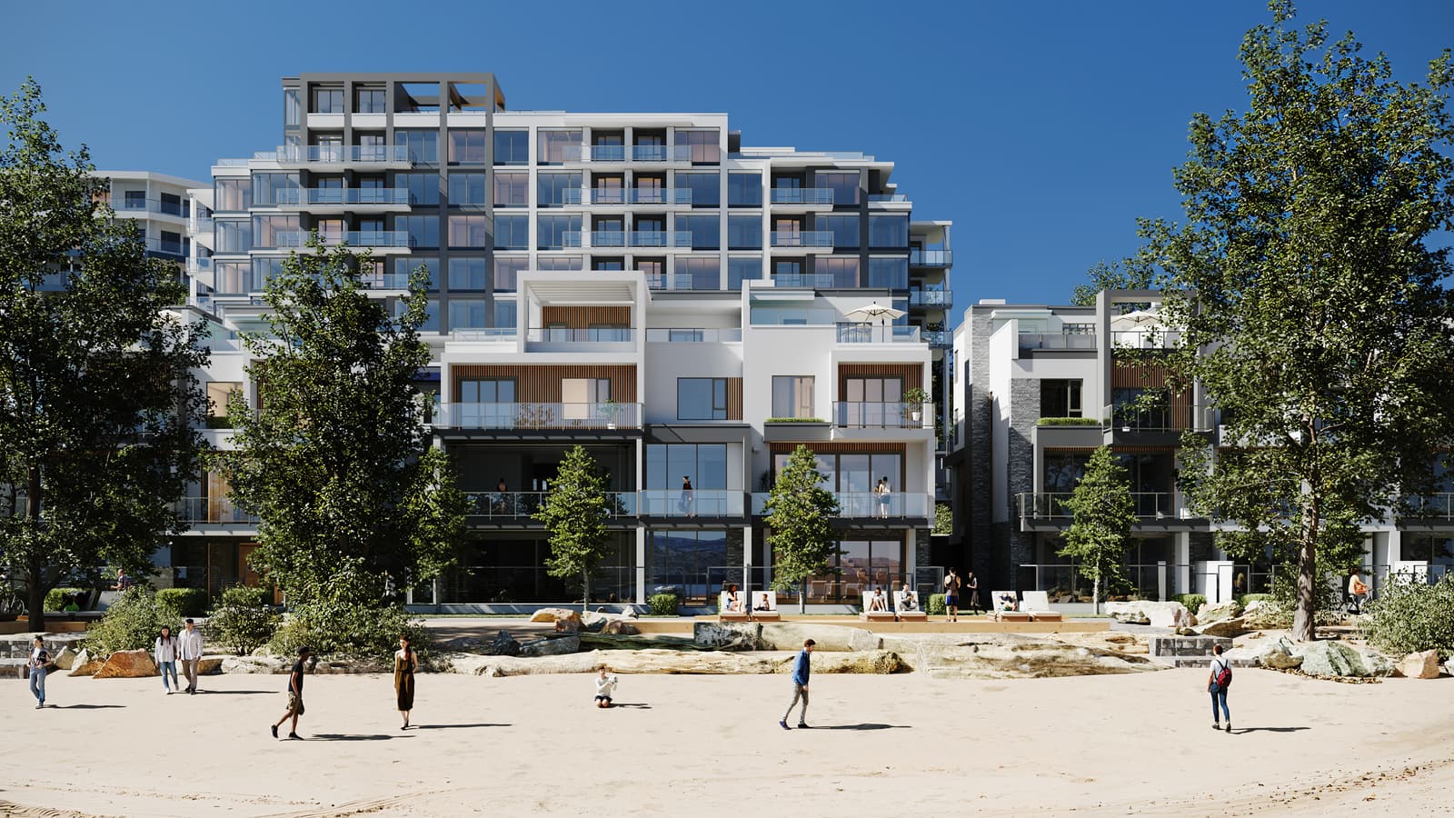 People playing on the sand in front of the Waterfront Tower and the villas on a summer day