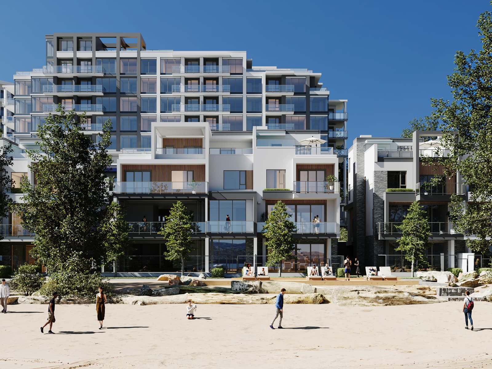 People playing on the white sand beach in front of the Waterfront Tower and the villas on a summer day