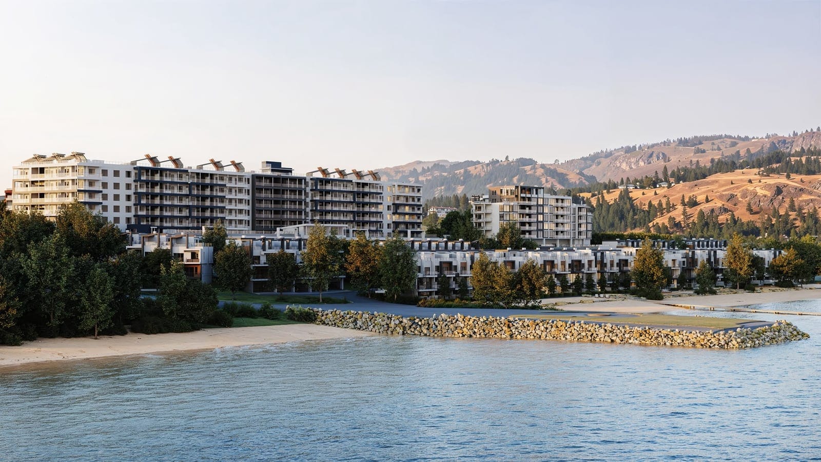 Westrich Bay seen from Okanagan Lake: the tower, villas, beach and rock breakwater below the West Kelowna hills