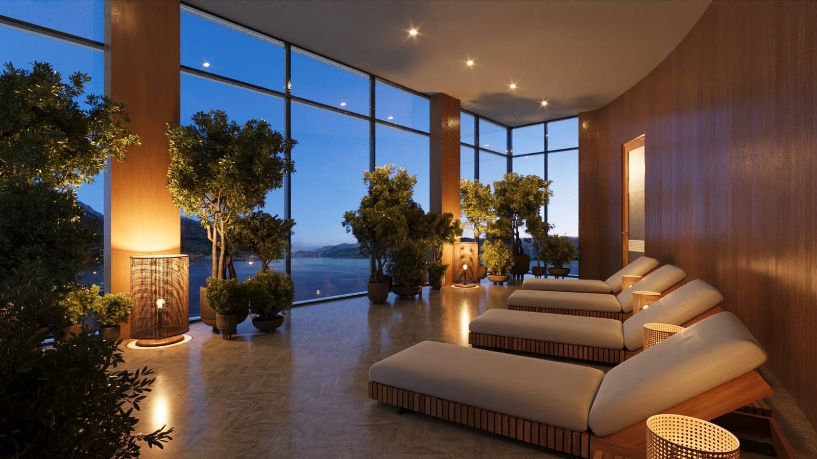 Relaxation lounge with loungers, plants and lake views at dusk