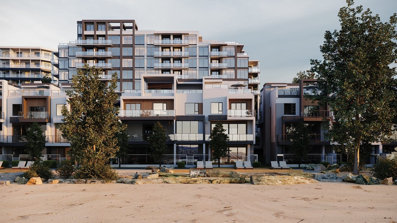 The Waterfront Tower rising behind the beachfront villas, seen from the white sand beach