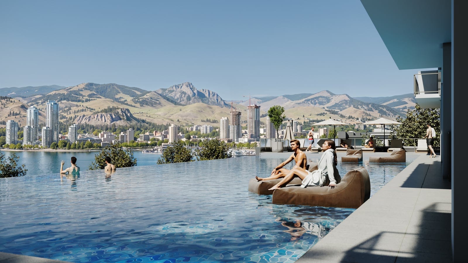 Swimmers and loungers in the Waterfront Tower’s infinity pool, looking across Okanagan Lake to downtown Kelowna and the mountains
