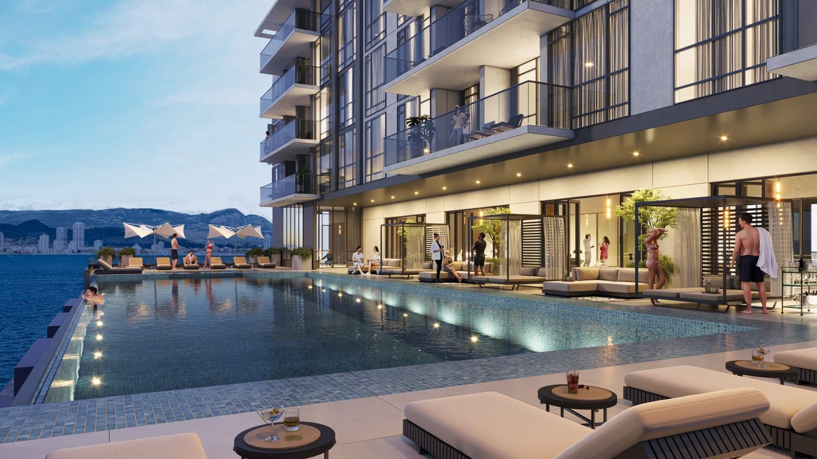 Waterfront Tower infinity pool deck lit in the evening above Okanagan Lake