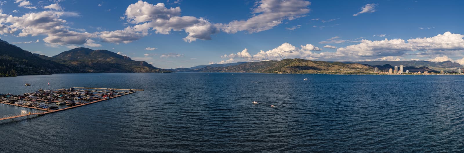 The actual view across Okanagan Lake from Westrich Bay: the neighbouring West Harbour community marina, boats on the lake and downtown Kelowna across the water