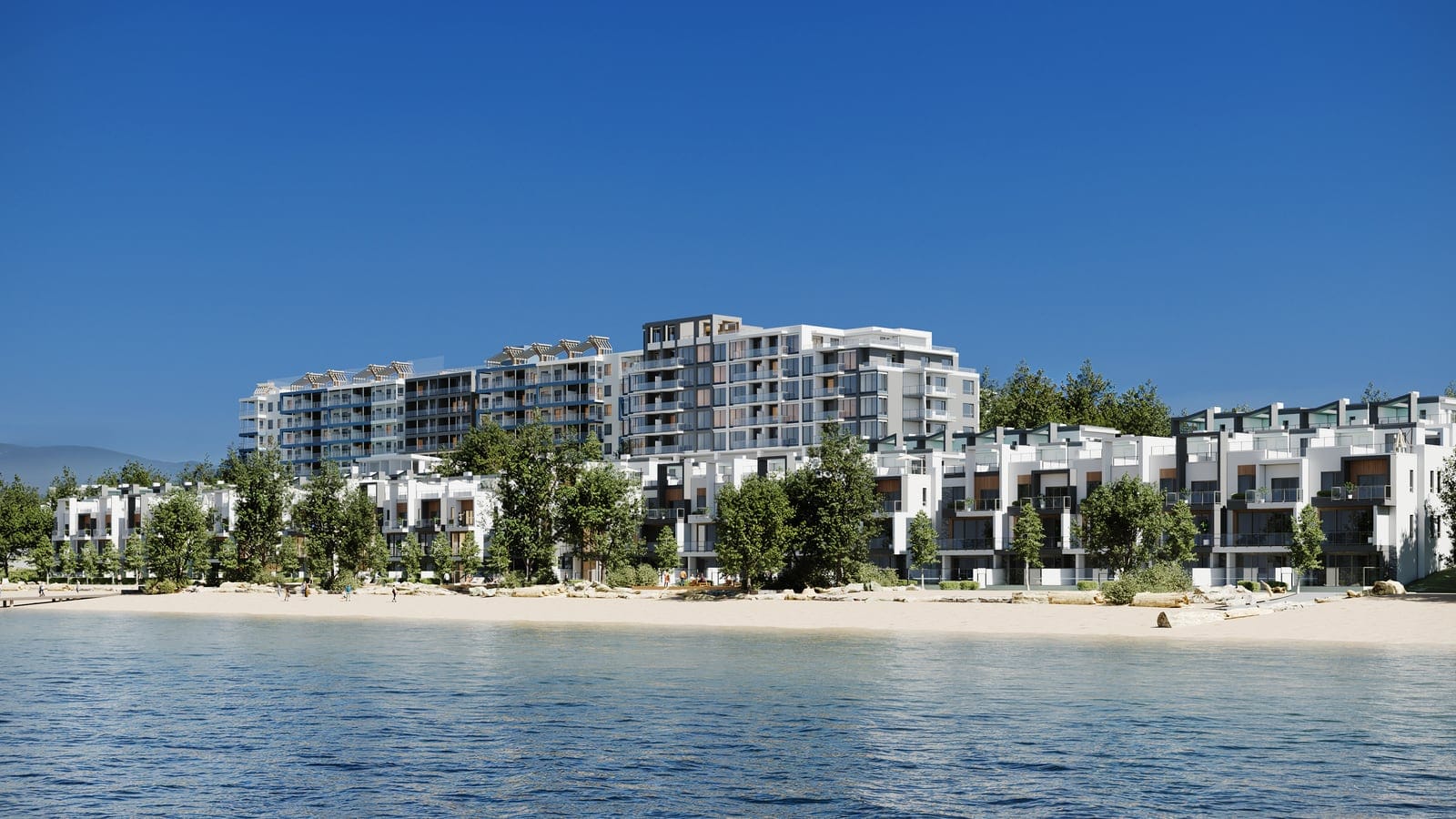 The waterfront villas along the white sand beach with the Waterfront Tower behind, seen from Okanagan Lake on a sunny day